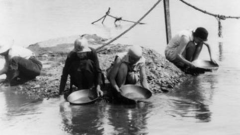 four women panning for gold